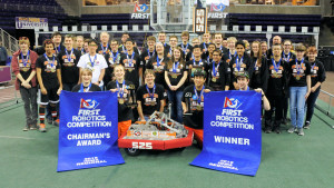 FRC Team 525 group photo with season robot and banners.