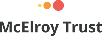 McElroy Trust Logo - Yellow, orange, and peach dots over the text McElroy Trust.